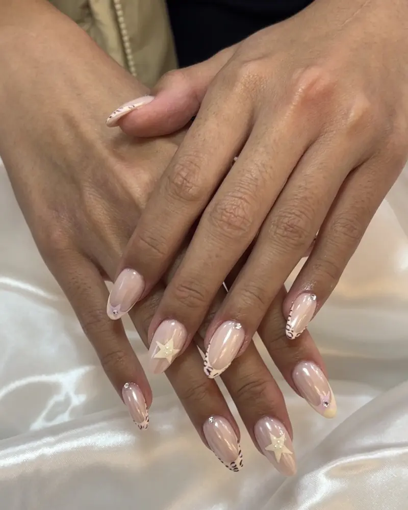 Milky almond nails with leopard French tips and 3D stars at Chillux Nails, Orpington